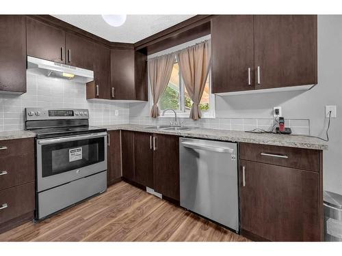 10 Falchurch Road Ne, Calgary, AB - Indoor Photo Showing Kitchen With Double Sink