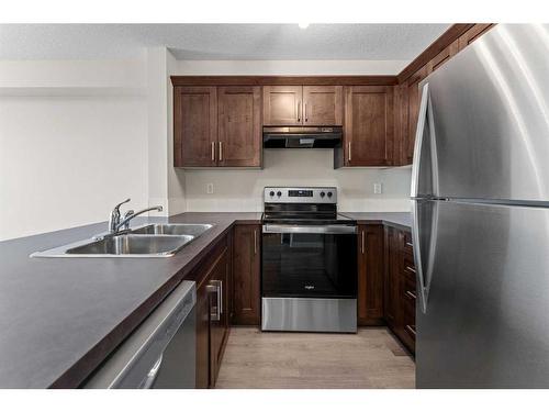 1216-130 Panatella Street Nw, Calgary, AB - Indoor Photo Showing Kitchen With Stainless Steel Kitchen With Double Sink