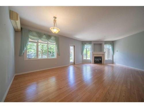 1110-1110 Lake Fraser Green Se, Calgary, AB - Indoor Photo Showing Living Room With Fireplace