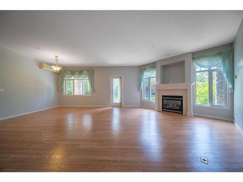 1110-1110 Lake Fraser Green Se, Calgary, AB - Indoor Photo Showing Living Room With Fireplace