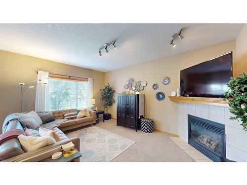 157 Chapalina Close Se, Calgary, AB - Indoor Photo Showing Living Room With Fireplace
