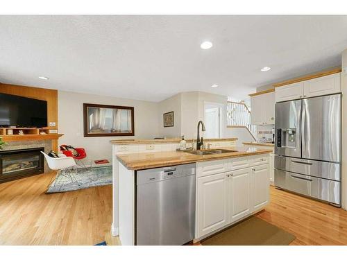 1650 Westmount Boulevard Nw, Calgary, AB - Indoor Photo Showing Kitchen With Fireplace With Double Sink