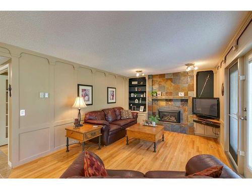 123 Ranchridge Bay Nw, Calgary, AB - Indoor Photo Showing Living Room With Fireplace