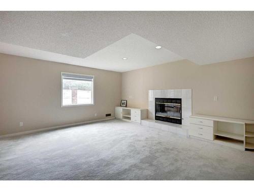 117 Candle Place Sw, Calgary, AB - Indoor Photo Showing Other Room With Fireplace
