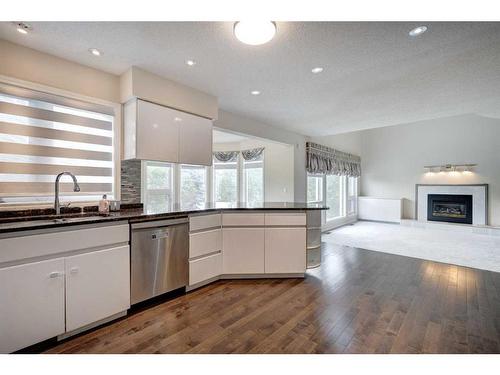 117 Candle Place Sw, Calgary, AB - Indoor Photo Showing Kitchen With Fireplace