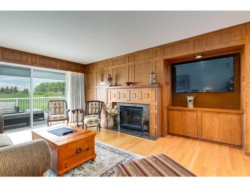 100A-17177 306 Avenue East, Rural Foothills County, AB - Indoor Photo Showing Living Room With Fireplace