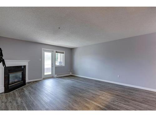 108-790 Kingsmere Crescent Sw, Calgary, AB - Indoor Photo Showing Living Room With Fireplace