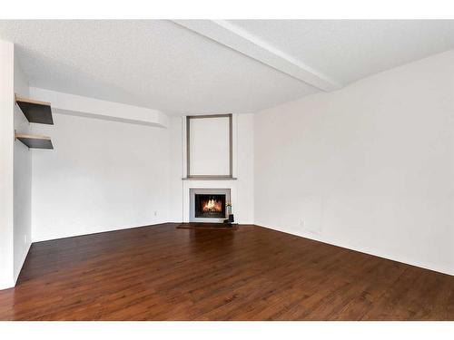 74-5520 1 Avenue Se, Calgary, AB - Indoor Photo Showing Other Room With Fireplace