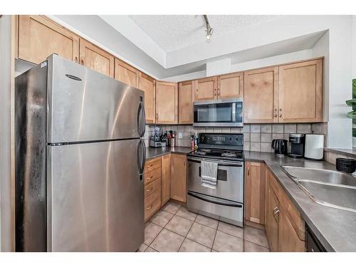 2-145 Rockyledge View Nw, Calgary, AB - Indoor Photo Showing Kitchen With Double Sink