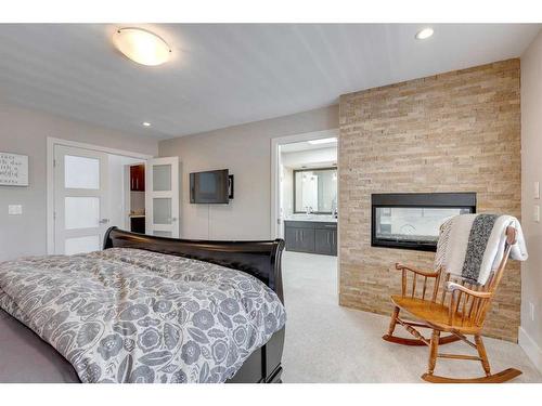 917 35 Street Nw, Calgary, AB - Indoor Photo Showing Bedroom With Fireplace