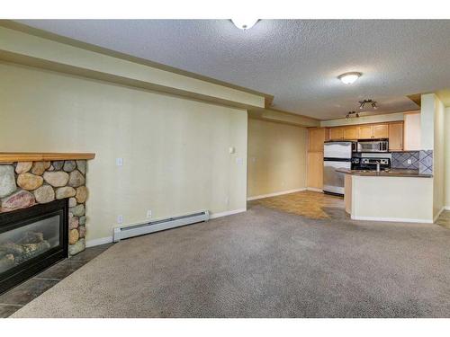 123-369 Rocky Vista Park Nw, Calgary, AB - Indoor Photo Showing Living Room With Fireplace
