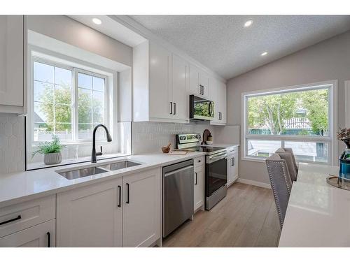 117 Rocky Ridge Landing Nw, Calgary, AB - Indoor Photo Showing Kitchen With Double Sink With Upgraded Kitchen