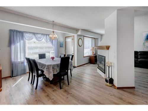 163 Citadel Park Nw, Calgary, AB - Indoor Photo Showing Dining Room With Fireplace