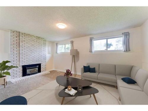 423 Brookmere Crescent Sw, Calgary, AB - Indoor Photo Showing Living Room With Fireplace