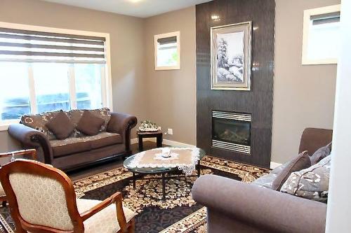 121 Lalor Drive Se, Red Deer, AB - Indoor Photo Showing Living Room With Fireplace