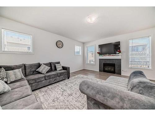 2102 Windbury Crescent Sw, Airdrie, AB - Indoor Photo Showing Living Room With Fireplace