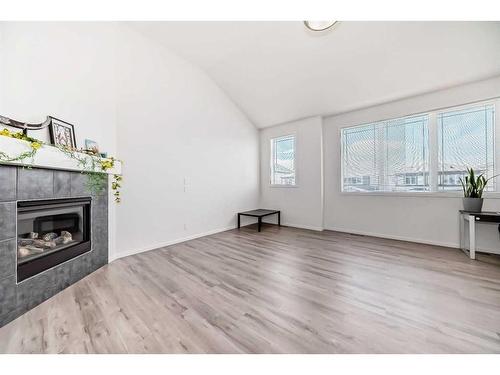 2102 Windbury Crescent Sw, Airdrie, AB - Indoor Photo Showing Living Room With Fireplace