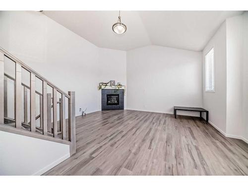 2102 Windbury Crescent Sw, Airdrie, AB - Indoor Photo Showing Other Room With Fireplace