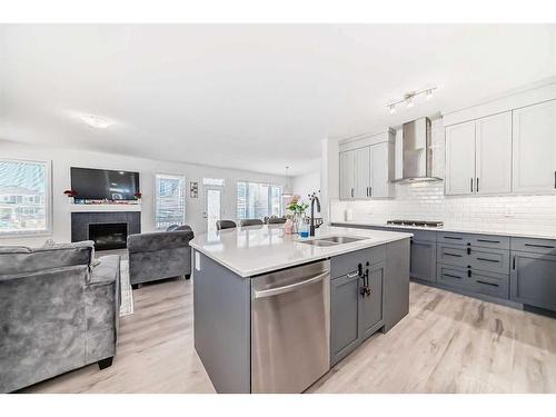 2102 Windbury Crescent Sw, Airdrie, AB - Indoor Photo Showing Kitchen With Fireplace With Upgraded Kitchen