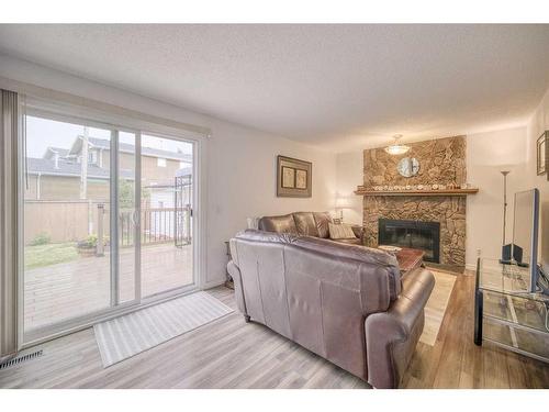 111 Hawkfield Crescent Nw, Calgary, AB - Indoor Photo Showing Living Room With Fireplace