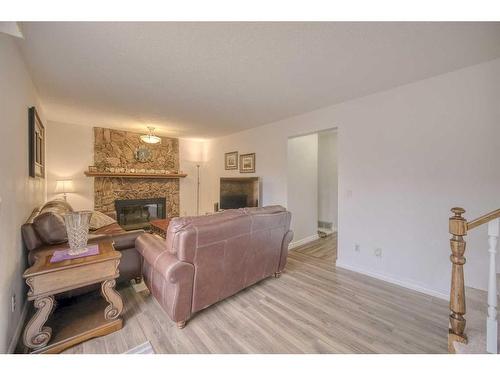 111 Hawkfield Crescent Nw, Calgary, AB - Indoor Photo Showing Living Room With Fireplace