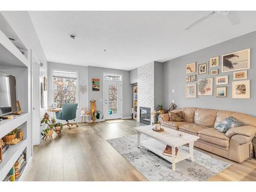 212-3650 Marda Link Sw, Calgary, AB - Indoor Photo Showing Living Room With Fireplace