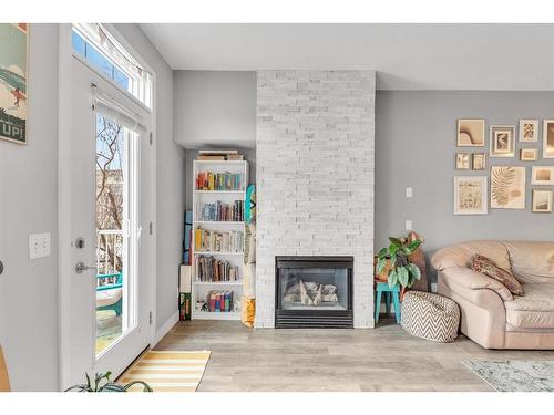 212-3650 Marda Link Sw, Calgary, AB - Indoor Photo Showing Living Room With Fireplace