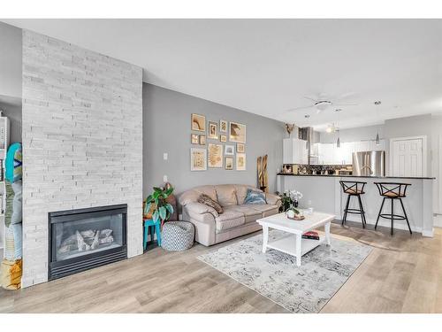 212-3650 Marda Link Sw, Calgary, AB - Indoor Photo Showing Living Room With Fireplace