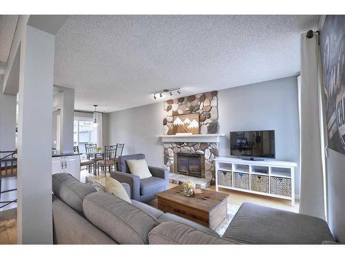15 Strathaven Circle Sw, Calgary, AB - Indoor Photo Showing Living Room With Fireplace