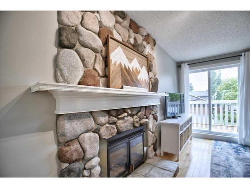 15 Strathaven Circle Sw, Calgary, AB - Indoor With Fireplace