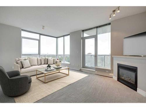 802-55 Spruce Place Sw, Calgary, AB - Indoor Photo Showing Living Room With Fireplace