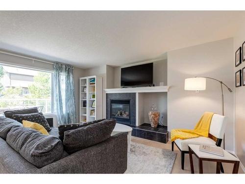 43 Cougarstone Common Sw, Calgary, AB - Indoor Photo Showing Living Room With Fireplace