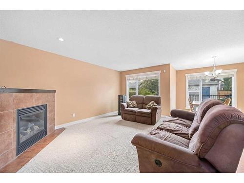 695 New Brighton Drive Se, Calgary, AB - Indoor Photo Showing Living Room With Fireplace