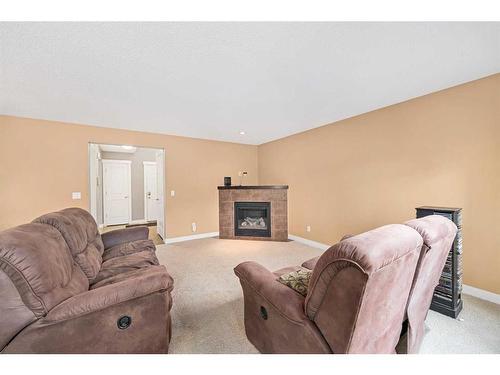 695 New Brighton Drive Se, Calgary, AB - Indoor Photo Showing Living Room With Fireplace