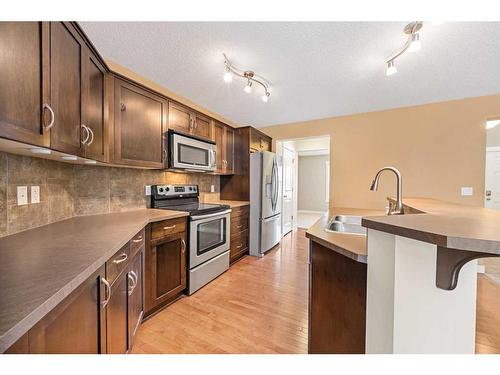 695 New Brighton Drive Se, Calgary, AB - Indoor Photo Showing Kitchen With Stainless Steel Kitchen With Double Sink