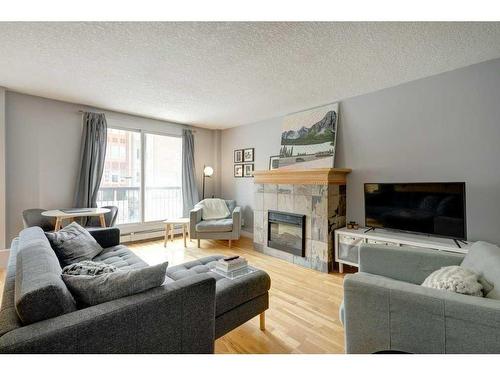 304-835 18 Avenue Sw, Calgary, AB - Indoor Photo Showing Living Room With Fireplace