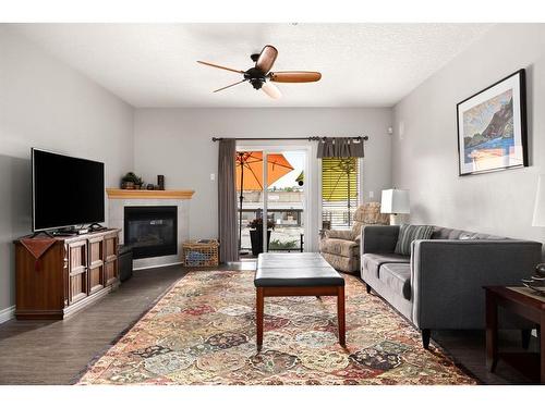 101-15212 Bannister Road Se, Calgary, AB - Indoor Photo Showing Living Room With Fireplace