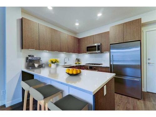 222-823 5 Avenue Nw, Calgary, AB - Indoor Photo Showing Kitchen With Stainless Steel Kitchen