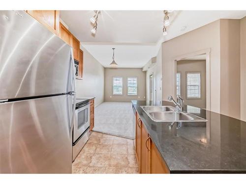 4111-11811 Lake Fraser Drive Se, Calgary, AB - Indoor Photo Showing Kitchen With Double Sink