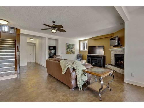 501 High Park Boulevard Nw, High River, AB - Indoor Photo Showing Living Room With Fireplace