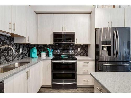 4412-215 Legacy Boulevard Se, Calgary, AB - Indoor Photo Showing Kitchen With Double Sink