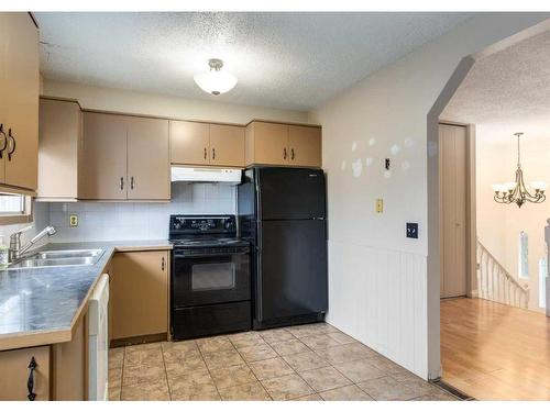 6144 Maddock Drive Ne, Calgary, AB - Indoor Photo Showing Kitchen With Double Sink