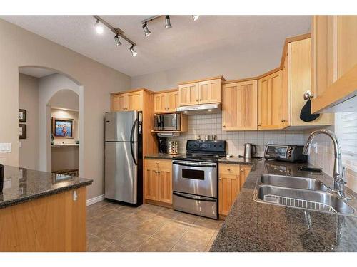 24 Straddock Villas Sw, Calgary, AB - Indoor Photo Showing Kitchen With Double Sink