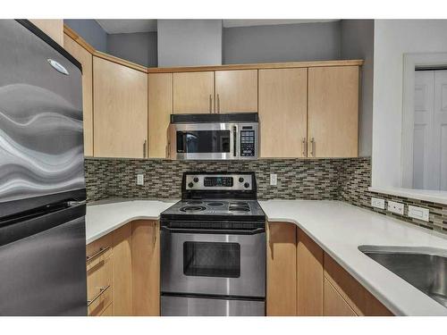 103-1414 17 Street Se, Calgary, AB - Indoor Photo Showing Kitchen With Stainless Steel Kitchen
