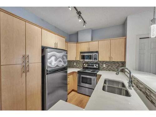 103-1414 17 Street Se, Calgary, AB - Indoor Photo Showing Kitchen With Stainless Steel Kitchen With Double Sink