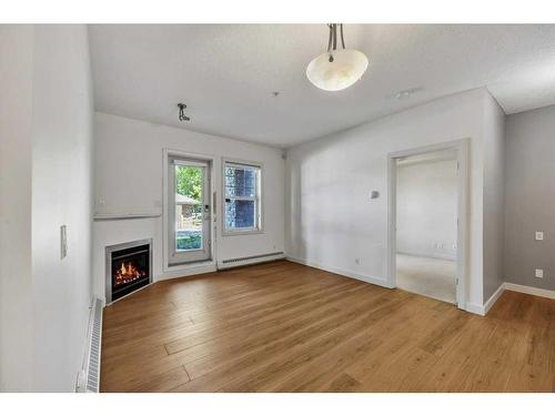 103-1414 17 Street Se, Calgary, AB - Indoor With Fireplace