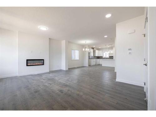 372 Heartland Way, Cochrane, AB - Indoor Photo Showing Living Room With Fireplace