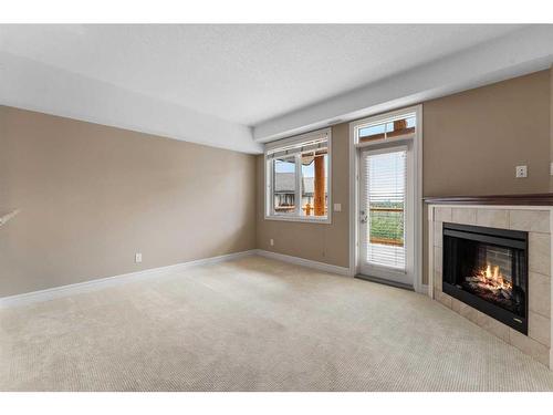 2418-2330 Fish Creek Boulevard Sw, Calgary, AB - Indoor Photo Showing Living Room With Fireplace