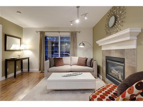 14-2318 17 Street Se, Calgary, AB - Indoor Photo Showing Living Room With Fireplace