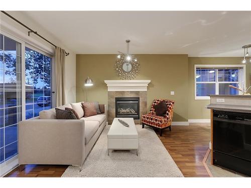 14-2318 17 Street Se, Calgary, AB - Indoor Photo Showing Living Room With Fireplace